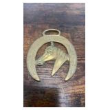 2 brass racing horse themed medallions