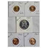1963 Franklin Half Dollar, graded MS-69, plus four pennies from 1961 and 1963 with varying grades and defects.