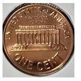 1963 Franklin Half Dollar, graded MS-69, plus four pennies from 1961 and 1963 with varying grades and defects.