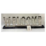 Two Abstract Metal Sculptures and Welcome Sign