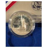 United States Liberty Coins 1986 - Ellis Island Silver Dollar & Statue of Liberty Half Dollar (Lot of 2)
