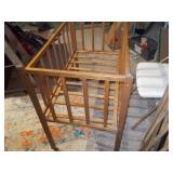 This appears to be a vintage wooden baby crib or bassinet,
