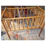 This appears to be a vintage wooden baby crib or bassinet,