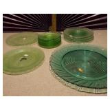 The image displays various sets of vintage green glass plates and bowls,
