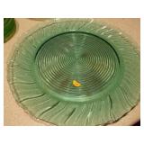 The image displays various sets of vintage green glass plates and bowls,