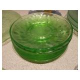 The image displays various sets of vintage green glass plates and bowls,