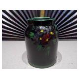This is a vintage antique McCoy lidded crock cookie jar with a floral design.