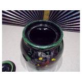 This is a vintage antique McCoy lidded crock cookie jar with a floral design.