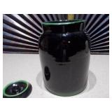 This is a vintage antique McCoy lidded crock cookie jar with a floral design.