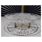 This is a vintage Federal Glass "Leaf and Dot" pattern clear glass lazy susan relish tray with an attached gold-tone footed stand.