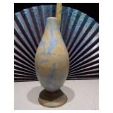 This is a handmade porcelain vase with a blue and rust crystalline glaze