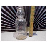 This is a vintage Marigold Dairy Products clear glass milk bottle