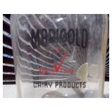This is a vintage Marigold Dairy Products clear glass milk bottle
