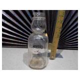 This is a vintage Marigold Dairy Products clear glass milk bottle