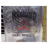 This is a vintage Marigold Dairy Products clear glass milk bottle