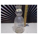 This is a vintage glass milk bottle.