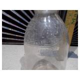 This is a vintage glass milk bottle.