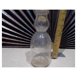 This is a vintage glass milk bottle.