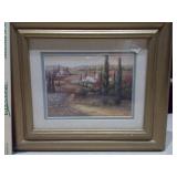 The image displays two framed art prints