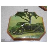 These are vintage wall plaques featuring art of antique cars
