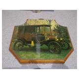 These are vintage wall plaques featuring art of antique cars