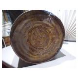 The can is a large, blue metal drum with a heavily worn paper label