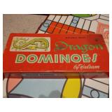 The image displays a collection of vintage board games, including a Parcheesi board and boxes, a backgammon board, and two boxes of HALSAM "Dragon Dominos