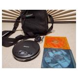 This appears to be a Memorex MD6451 portable CD player along with a Case Logic carrying case and two CDs.