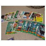 The image displays a lot of assorted sports trading cards and collectibles, primarily featuring vintage baseball cards from the late 1980s