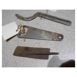 several "church key" style can and bottle openers, spoons, and other small metal objects.