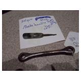 several "church key" style can and bottle openers, spoons, and other small metal objects.