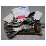 several "church key" style can and bottle openers, spoons, and other small metal objects.