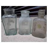 The image displays a collection of vintage glass bottles and shot glasses