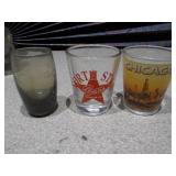 The image displays a collection of vintage glass bottles and shot glasses