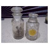 The image displays a collection of vintage glass bottles and shot glasses