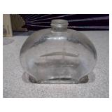 The image displays a collection of vintage glass bottles and shot glasses