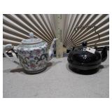 Chinese Famille Rose teapot and a second, black glazed teapot,