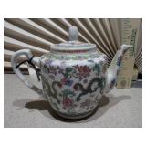 Chinese Famille Rose teapot and a second, black glazed teapot,