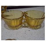 This is a collection of vintage Anchor Hocking Fairfield pattern amber glass dishes.