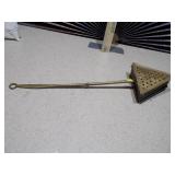 This is a vintage brass bed warmer, also known as a warming pan