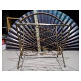 This is a mid-century modern atomic brass magazine rack