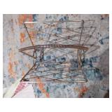 This is a mid-century modern atomic brass magazine rack