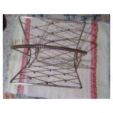 This is a mid-century modern atomic brass magazine rack