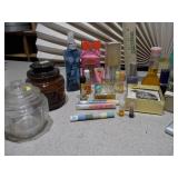 The collection includes various sizes, shapes, and colors of glass bottles