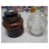 The collection includes various sizes, shapes, and colors of glass bottles