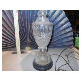 This is a cut glass table lamp with a fabric shade.