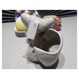 The image displays several collectible figurines