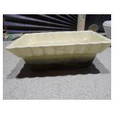 The image features several ceramic planters,