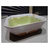 The image features several ceramic planters,