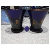 The image displays a collection of various cobalt blue glass items,